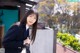 A woman in a school uniform posing for a picture.