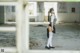 A woman in a school uniform standing in an abandoned building.